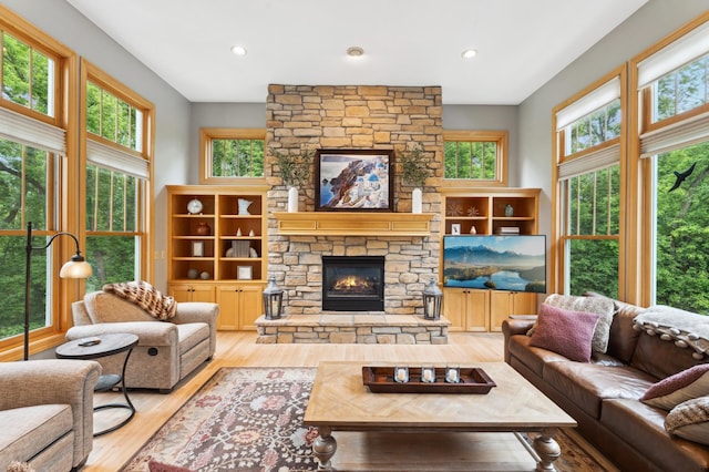 6539 Orchard Ridge Trl, Woodbury, MN 55129 - living room featuring a stone fireplace, wood finished floors, and recessed lighting