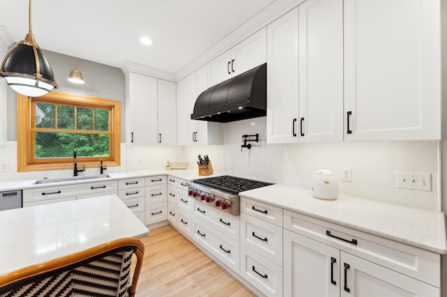 6539 Orchard Ridge Trl, Woodbury, MN 55129 - kitchen featuring under cabinet range hood, stainless steel gas cooktop, a sink, decorative backsplash, and white cabinetry