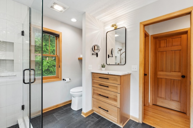 6539 Orchard Ridge Trl, Woodbury, MN 55129 - full bathroom with vanity, a shower stall, baseboards, toilet, and recessed lighting