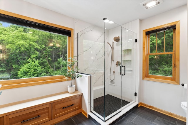 6539 Orchard Ridge Trl, Woodbury, MN 55129 - bathroom with a marble finish shower, toilet, tile patterned flooring, and baseboards