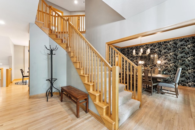 6539 Orchard Ridge Trl, Woodbury, MN 55129 - staircase featuring wood finished floors, a chandelier, and baseboards