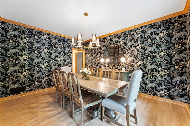 6539 Orchard Ridge Trl, Woodbury, MN 55129 - dining space featuring wallpapered walls, a chandelier, wood finished floors, baseboards, and ornamental molding