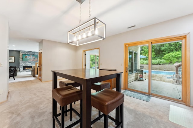 6539 Orchard Ridge Trl, Woodbury, MN 55129 - dining room with light carpet and a stone fireplace