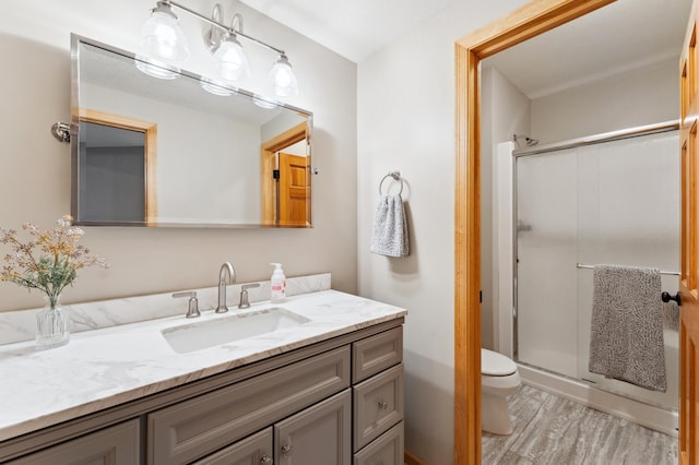6539 Orchard Ridge Trl, Woodbury, MN 55129 - bathroom featuring vanity, a shower stall, toilet, and wood finished floors