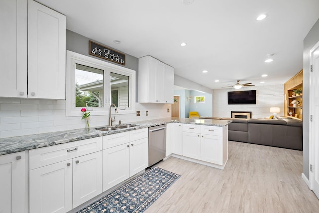 1305 Unity Ave N, Golden Valley, MN 55422 - kitchen with dishwasher, a sink, a peninsula, a ceiling fan, and a large fireplace