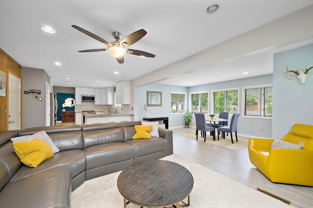 1305 Unity Ave N, Golden Valley, MN 55422 - living area featuring a ceiling fan, light wood finished floors, baseboards, and recessed lighting