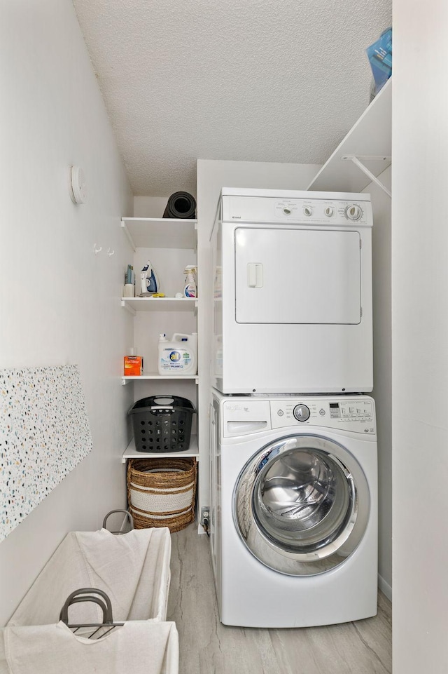 1305 Unity Ave N, Golden Valley, MN 55422 - laundry area featuring stacked washer and clothes dryer, a textured ceiling, and wood finished floors