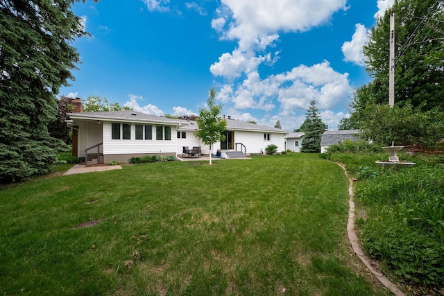 1305 Unity Ave N, Golden Valley, MN 55422 - back of house featuring a patio area, entry steps, a chimney, and a lawn