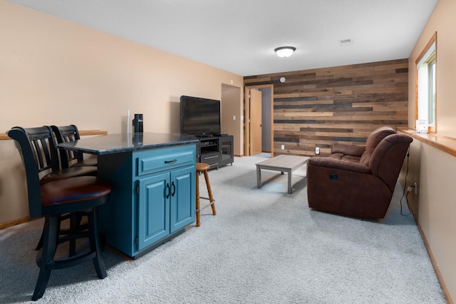 3138 Olympus Dr NE, Sauk Rapids, MN 56379 - living room with wooden walls, light colored carpet, an accent wall, and baseboards