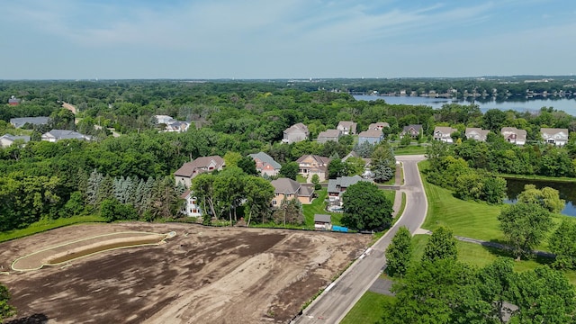 aerial view of residential area featuring a large body of water