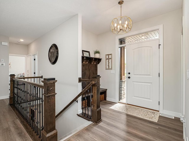3309 171st Ave NE, Ham Lake, MN 55304 - foyer entrance featuring wood finished floors, a chandelier, and recessed lighting