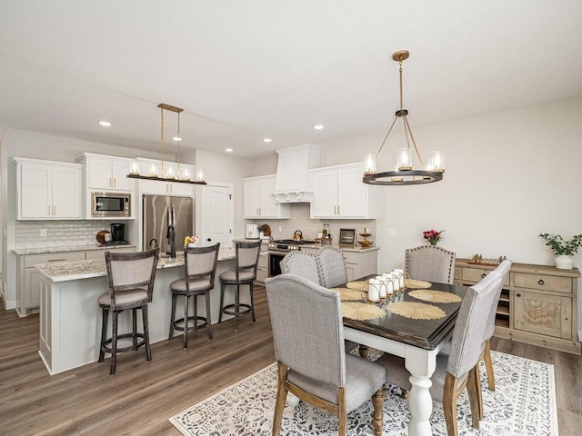 3309 171st Ave NE, Ham Lake, MN 55304 - dining room featuring a chandelier, wood finished floors, and recessed lighting