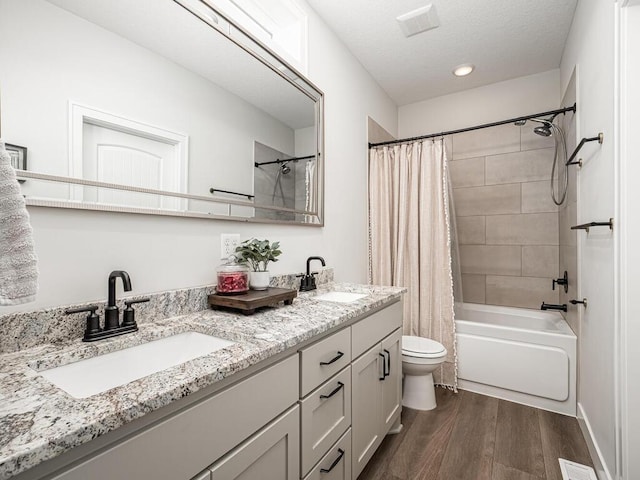 3309 171st Ave NE, Ham Lake, MN 55304 - full bath featuring double vanity, wood finished floors, shower / bath combo, and recessed lighting