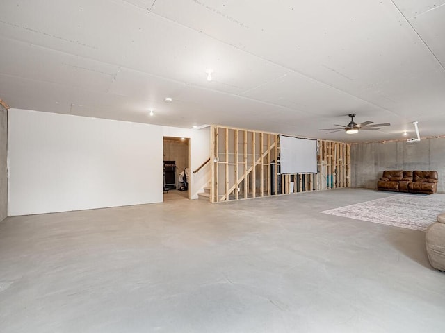 3309 171st Ave NE, Ham Lake, MN 55304 - unfurnished living room featuring concrete flooring, stairway, and ceiling fan