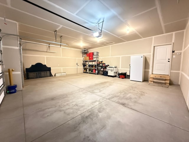 3309 171st Ave NE, Ham Lake, MN 55304 - garage with freestanding refrigerator and a garage door opener