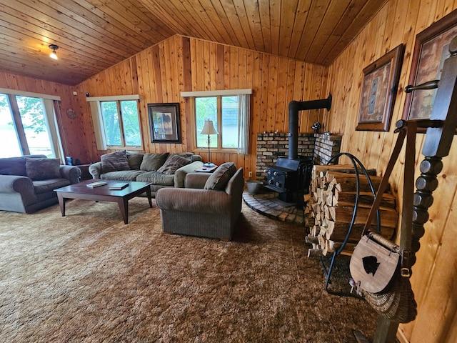 27042 Bluebill Point Rd, Garrison, MN 56450 - carpeted living area featuring lofted ceiling, wooden walls, a wood stove, and wood ceiling
