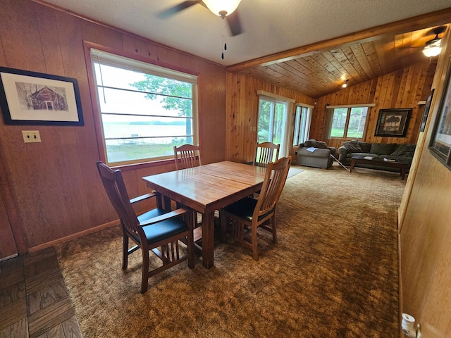 27042 Bluebill Point Rd, Garrison, MN 56450 - carpeted dining room featuring a ceiling fan, wooden walls, and lofted ceiling