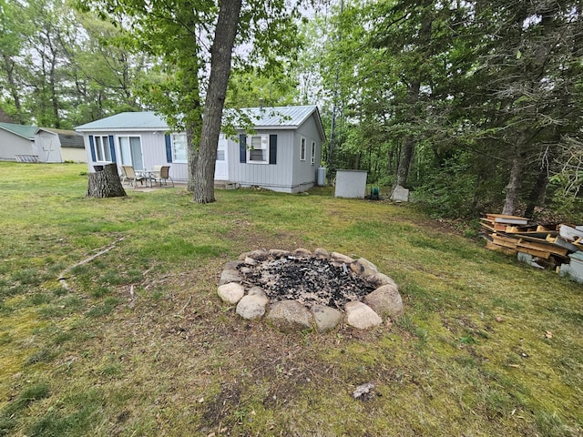 27042 Bluebill Point Rd, Garrison, MN 56450 - view of grassy yard with an outdoor fire pit