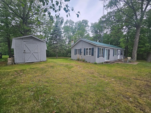 27042 Bluebill Point Rd, Garrison, MN 56450 - view of side of property featuring a chimney, a lawn, a patio, and view of wooded area