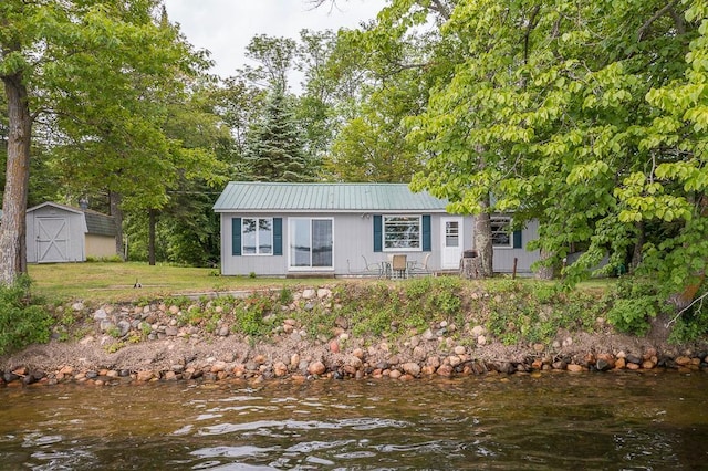 27042 Bluebill Point Rd, Garrison, MN 56450 - single story home featuring metal roof, a water view, and a front yard