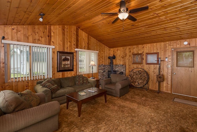 27042 Bluebill Point Rd, Garrison, MN 56450 - living room featuring a wood stove, vaulted ceiling, wood ceiling, wooden walls, and a ceiling fan