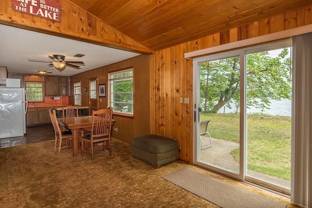27042 Bluebill Point Rd, Garrison, MN 56450 - dining room with lofted ceiling, wooden walls, and ceiling fan