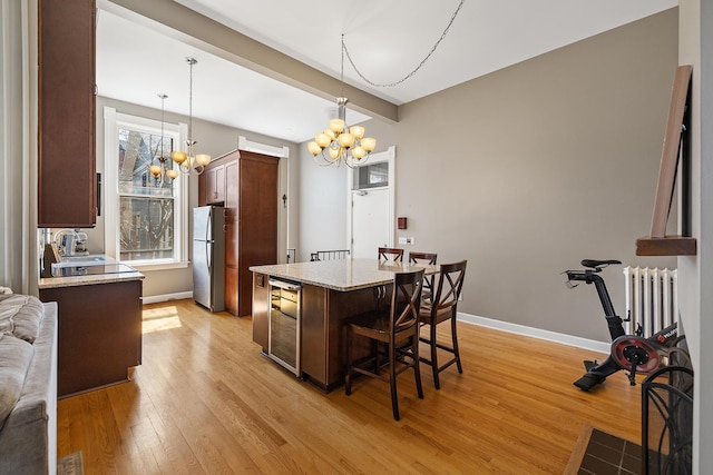 112 Western Ave N Unit 4, Saint Paul, MN 55102 - dining space featuring a chandelier, light wood-style floors, wine cooler, baseboards, and beam ceiling