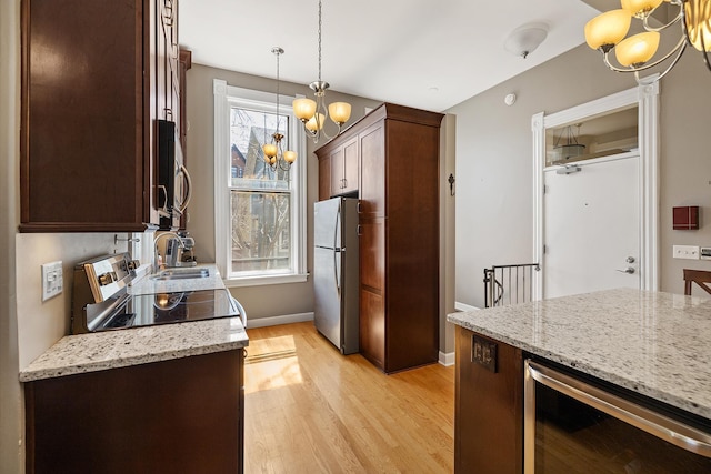 112 Western Ave N Unit 4, Saint Paul, MN 55102 - kitchen featuring beverage cooler, a chandelier, appliances with stainless steel finishes, a sink, and light wood-style floors