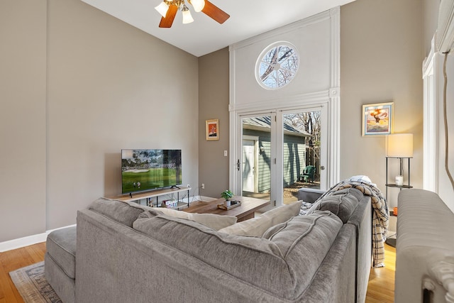 112 Western Ave N Unit 4, Saint Paul, MN 55102 - living room with a high ceiling, a ceiling fan, light wood-style flooring, and baseboards