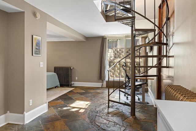 112 Western Ave N Unit 4, Saint Paul, MN 55102 - unfurnished dining area with stone tile floors, stairs, baseboards, and radiator