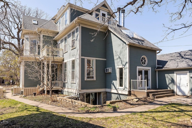 112 Western Ave N Unit 4, Saint Paul, MN 55102 - view of home's exterior featuring a balcony, a shingled roof, and cooling unit