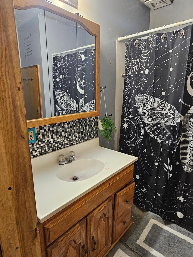 413 7th St W, Canby, MN 56220 - bathroom with vanity, backsplash, and a shower with curtain
