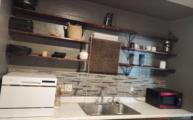 413 7th St W, Canby, MN 56220 - kitchen with black microwave, open shelves, a sink, decorative backsplash, and light countertops