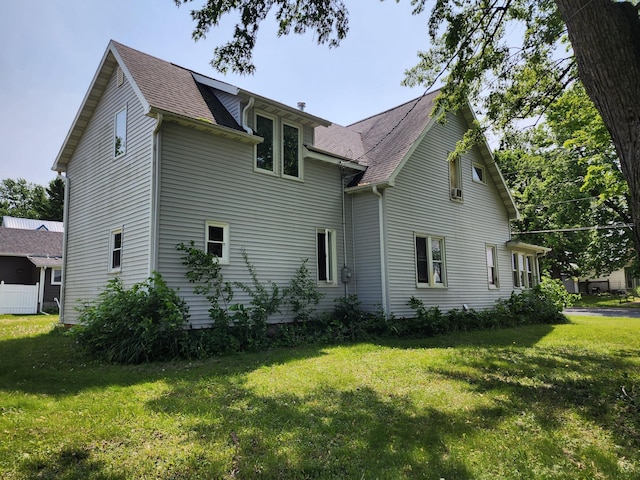 315 3rd St SW, Stewartville, MN 55976 - view of home's exterior featuring a shingled roof and a yard