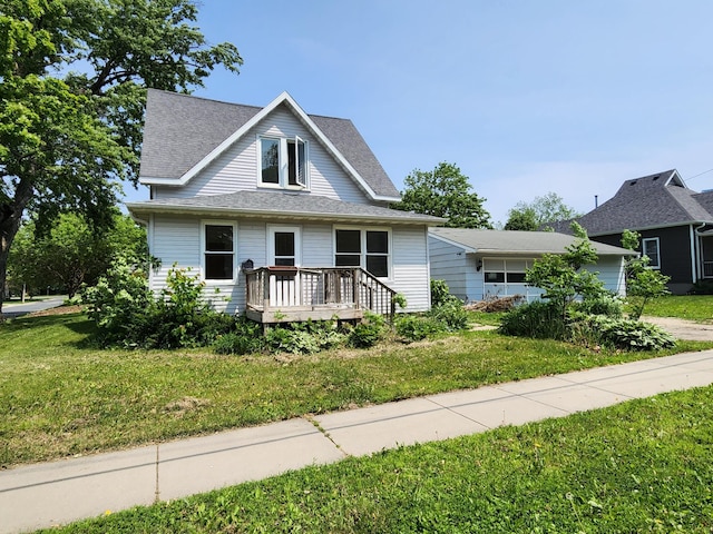 315 3rd St SW, Stewartville, MN 55976 - bungalow with a front lawn, a shingled roof, and a deck