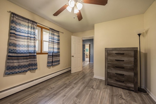 836 Milligan Ave, Wabasha, MN 55981 - unfurnished bedroom featuring a baseboard radiator, wood finished floors, baseboards, and a ceiling fan