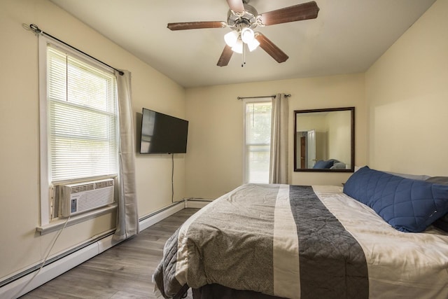 836 Milligan Ave, Wabasha, MN 55981 - bedroom with wood finished floors, cooling unit, a ceiling fan, and a baseboard heating unit