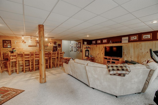8824 Bittersweet Cir, Breezy Point, MN 56472 - carpeted living room featuring wood walls, a drop ceiling, and bar