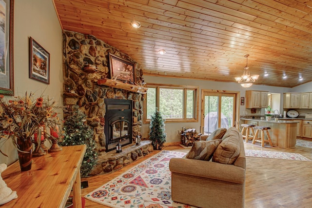 8824 Bittersweet Cir, Breezy Point, MN 56472 - living room featuring wood ceiling, light wood-style flooring, lofted ceiling, a chandelier, and a stone fireplace