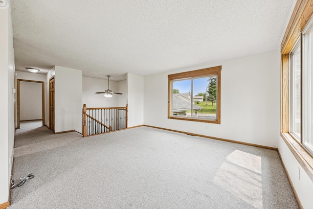 2140 Prospect Dr NE, Saint Cloud, MN 56304 - unfurnished room with a textured ceiling, carpet, baseboards, and ceiling fan