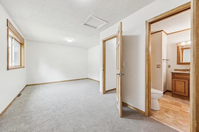 2140 Prospect Dr NE, Saint Cloud, MN 56304 - below grade area with light carpet, a textured ceiling, baseboards, and a sink