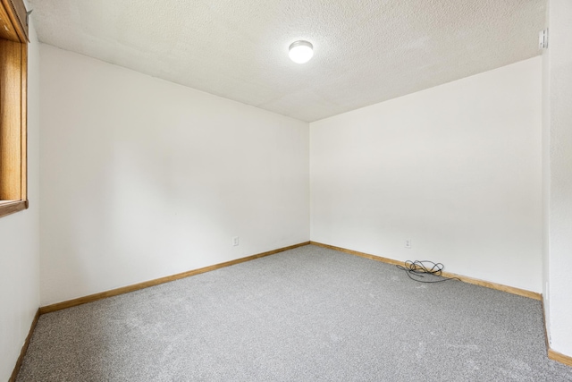 2140 Prospect Dr NE, Saint Cloud, MN 56304 - carpeted spare room featuring a textured ceiling and baseboards