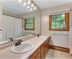 1335 Cooper Ave S, Saint Cloud, MN 56301 - full bathroom featuring a baseboard heating unit, double vanity, and healthy amount of natural light