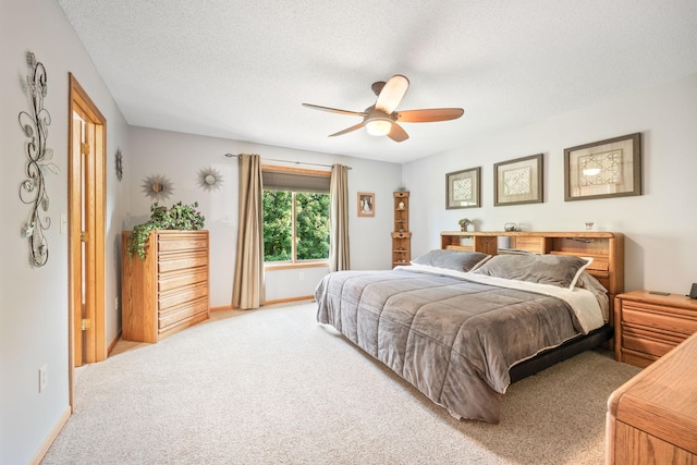 1893 White Oak Dr, Chaska, MN 55318 - carpeted bedroom featuring baseboards, a textured ceiling, and a ceiling fan