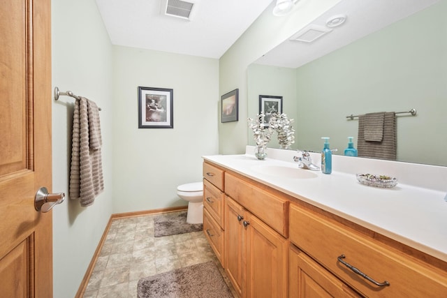 1893 White Oak Dr, Chaska, MN 55318 - bathroom with baseboards, vanity, toilet, and stone finish floors