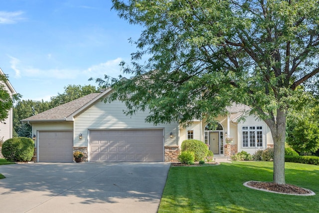 1893 White Oak Dr, Chaska, MN 55318 - obstructed view of property featuring a garage, concrete driveway, a front lawn, stone siding, and a shingled roof