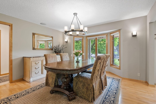 6136 Arctic Way, Edina, MN 55436 - dining area with light wood-style flooring, a chandelier, a textured ceiling, and baseboards