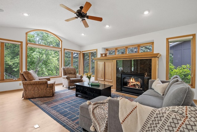 6136 Arctic Way, Edina, MN 55436 - living room featuring lofted ceiling, wood finished floors, a premium fireplace, ceiling fan, and recessed lighting