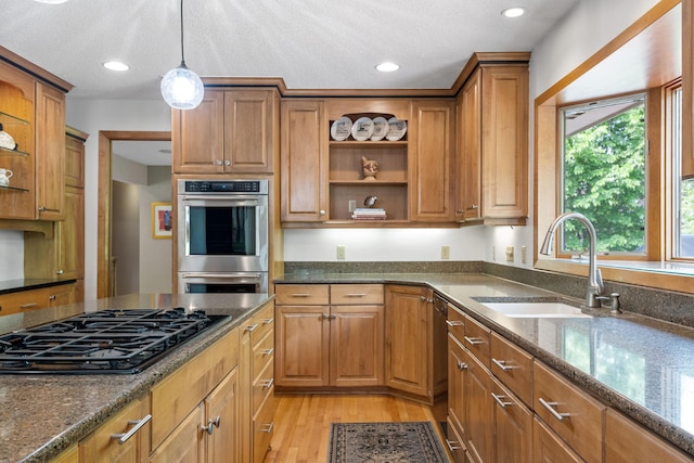 6136 Arctic Way, Edina, MN 55436 - kitchen with black gas cooktop, double oven, open shelves, brown cabinetry, and dark stone countertops