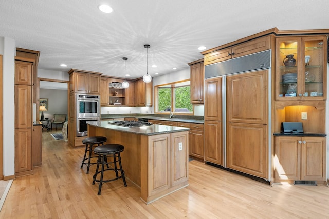 6136 Arctic Way, Edina, MN 55436 - kitchen featuring stainless steel appliances, dark countertops, open shelves, a center island, and a kitchen breakfast bar
